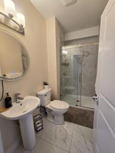 a bathroom with a toilet and a sink and a shower at 1 bedroom apartment in Halifax