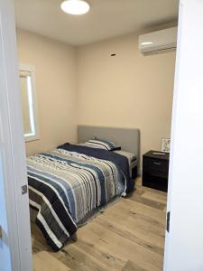 a bedroom with a bed and a dresser in it at 1 bedroom apartment in Halifax