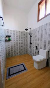 a bathroom with a white toilet and a window at Jaje Paje Villa in Paje +27 photos
