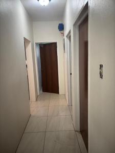an empty hallway with a door and a tile floor at Caroline suite in Cliftons
