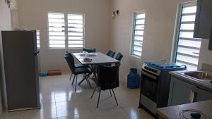 a small kitchen with a table and chairs in it at Caroline suite in Cliftons