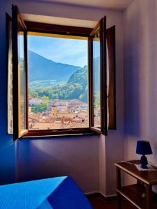 a window in a bedroom with a view of a city at L'Oleandro in Maratea +4 photos