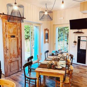 a dining room with a large wooden table and chairs at Guest House Nonna Giulina, camere - Rooms in Castagnole Lanze