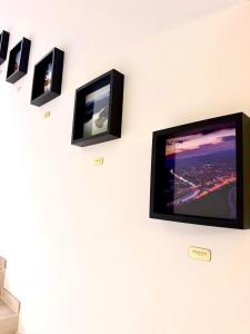 a flat screen tv hanging on a wall at Urban Base CELJE in Celje +17 photos