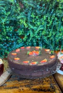 a chocolate cake sitting on top of a table at Pousada no Sana Donna Leda in Sana