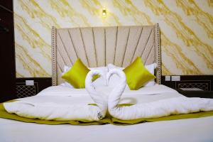 a bed with two swans made out of towels at Lee Njiru Resort in Nakuru