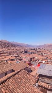 an aerial view of a city with roofs at Loki Cusco in Cusco