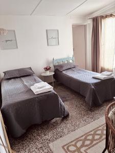 a bedroom with two beds and a window at Depto Güemes in Río Gallegos