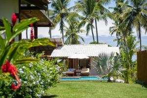 a villa with a pool and a resort with palm trees at Hygge Residence - Barra Grande - Península de Maraú in Marau