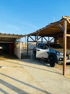 a truck parked in a garage with a roof at Holgger House in Talara +5 photos