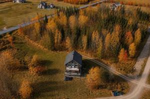 an aerial view of a small house in a field at Le Huppe - Spa Ski & River View in Petite-Rivière-Saint-François