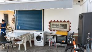 a laundry room with a washer and a table at Vitiello Maria's home in Pompei