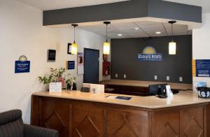 a reception desk in a dental office with a sign on the wall at Days Inn by Wyndham Topeka in Topeka +14 photos