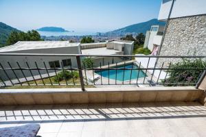 a house with a swimming pool on a balcony at Casa Mare & Monti in Budva