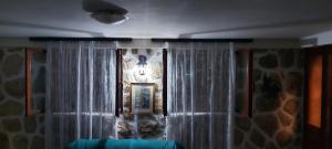a room with a curtain and a picture on the wall at Casa Mare & Monti in Budva +12 photos