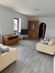 a living room with two couches and a tv at Reden in Illingen