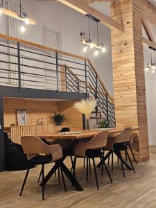 a dining room with a wooden table and chairs at FurtuNest in Roşcoiu +37 photos