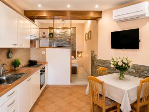 a kitchen with a table with a vase of flowers at Apartment Gaia with private parking in Portorož
