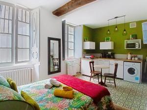 a bedroom with a bed and a table with chairs at Les Glycines Oloron in Oloron-Sainte-Marie