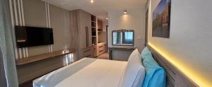a hotel room with a bed and a television at Elysee Vacances in Trou aux Biches
