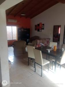 a living room with a dining room table and chairs at Marcelo Rivero in Catriel