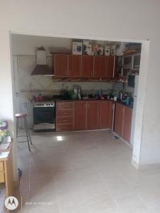 a kitchen with wooden cabinets and a stove at Marcelo Rivero in Catriel