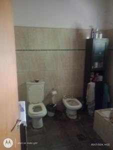 a bathroom with a toilet and a bidet at Marcelo Rivero in Catriel