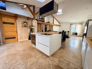 a kitchen with a white island in a room at L'Écrin de Valensole, Charme & terrasse in Valensole