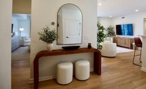 a living room with a table with a mirror at Wlk 2 MSU Fire Pit Pickleball Sleeps 8 in Starkville