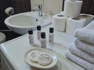 a bathroom with a sink and a counter with toiletries at Apartments Platz in Mostar +28 photos