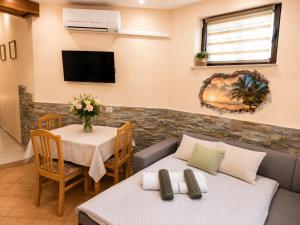 a living room with two beds and a table at Apartment Gaia with private parking in Portorož