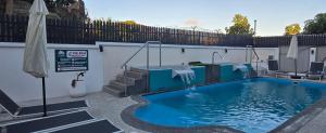 a swimming pool with a table and an umbrella at Elysee Vacances in Trou aux Biches