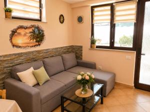 a living room with a couch and a table at Apartment Gaia with private parking in Portorož +5 photos