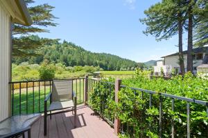 a balcony with a chair and a view of a field at West Sonoma Inn & Spa in Guerneville