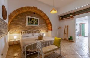 a bedroom with a bed and a brick wall at B&B Corso Garibaldi in Otranto