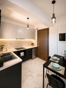 a kitchen with a sink and a table at Skyloft Meteora 1 in Kalabaka