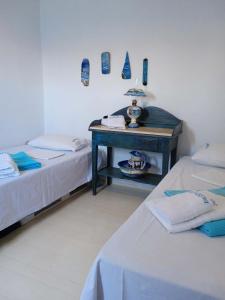 a room with two beds and a table in it at Palirroia (High Tide) in Empourios