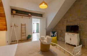a living room with a stone wall at B&B Corso Garibaldi in Otranto