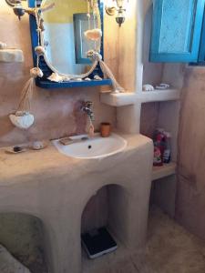 a bathroom with a sink and a mirror at Palirroia (High Tide) in Empourios +33 photos