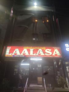 a sign on the front of a restaurant at night at HoTEL LAALASA in Vijayawāda