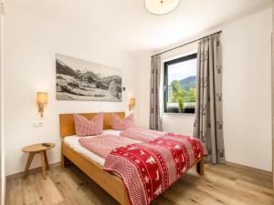 a bedroom with a bed and a window at Chalet Alpenzauber mit beheiztem Pool, Inzell in Inzell