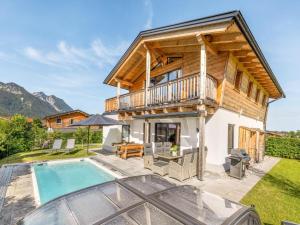 a villa with a pool and a house at Chalet Alpenzauber mit beheiztem Pool, Inzell in Inzell