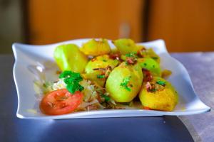 a plate of food with potatoes and vegetables on a table at Lee Njiru Resort in Nakuru