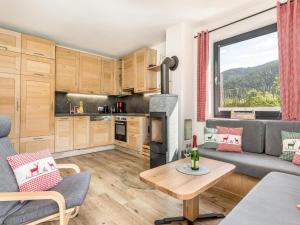 a living room with a couch and a table at Chalet Alpenzauber mit beheiztem Pool, Inzell in Inzell
