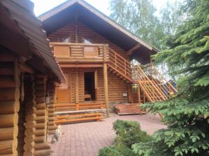 a log cabin with a staircase in front of it at Бухта Вікінга in Szack