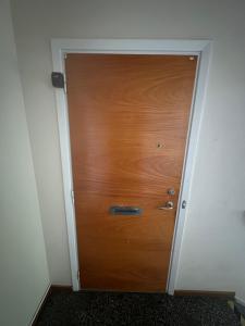 a wooden door in the corner of a room at Apartment in Skellefteå +3 photos