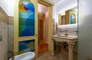 a bathroom with a sink and a stained glass window at B&B Corso Garibaldi in Otranto +38 photos