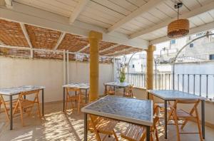 a patio with tables and chairs on a balcony at B&B Corso Garibaldi in Otranto