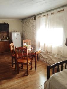 a kitchen with a table and chairs and a refrigerator at Estancia serena in Guichón