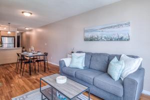 a living room with a blue couch and a table at Victoria Suites - Downtown in Toronto +16 photos